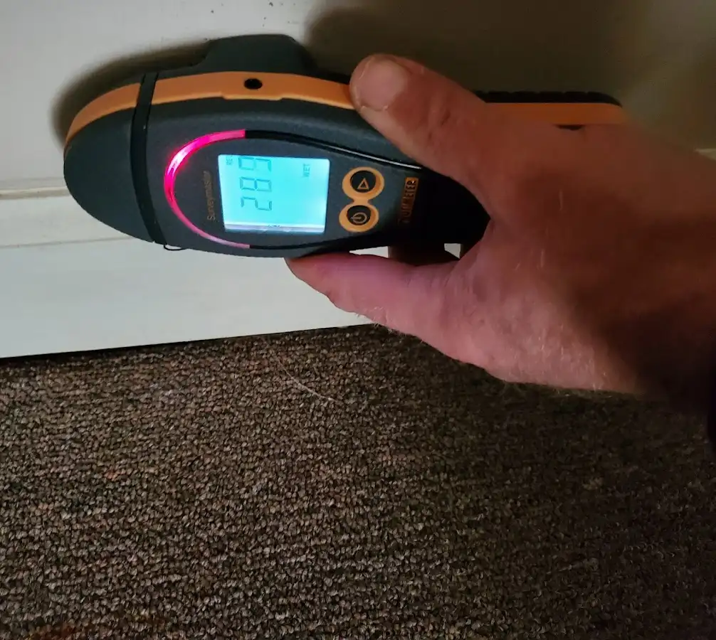 Moisture detection at baseboard during Storm Damage Restoration in Stratham